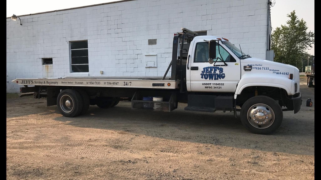 Jeff's Towing flatbed truck ready for roadside assistance